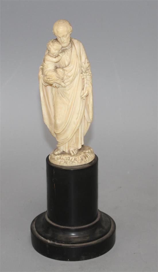 A 19th century Dieppe carved ivory figure of St Joseph holding the Christ child, 16cm, on ebony socle, overall height 26.5cm